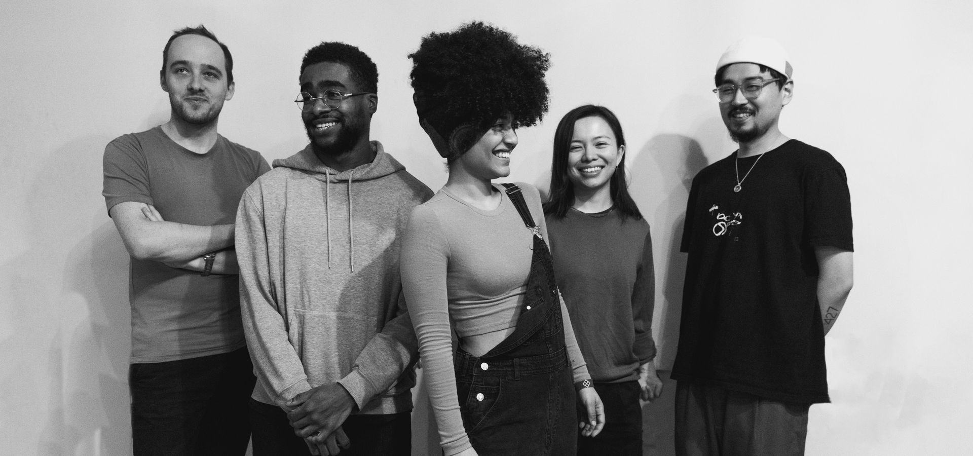 Milena and her band in front of a white background