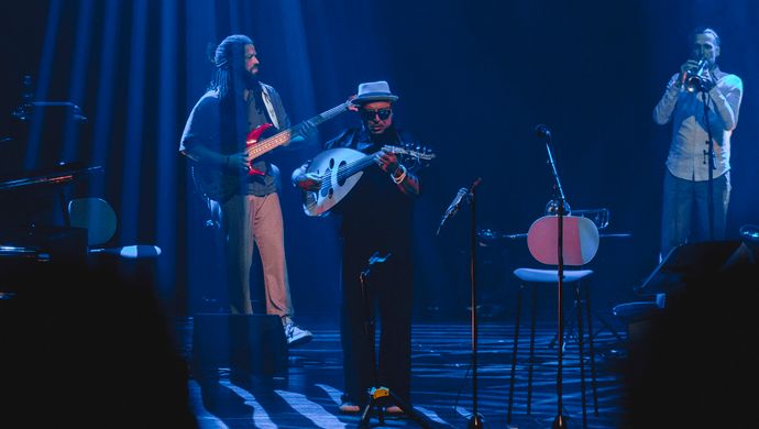 Guitarist, trumpeter and Dhafer Youssef on the stage. 
