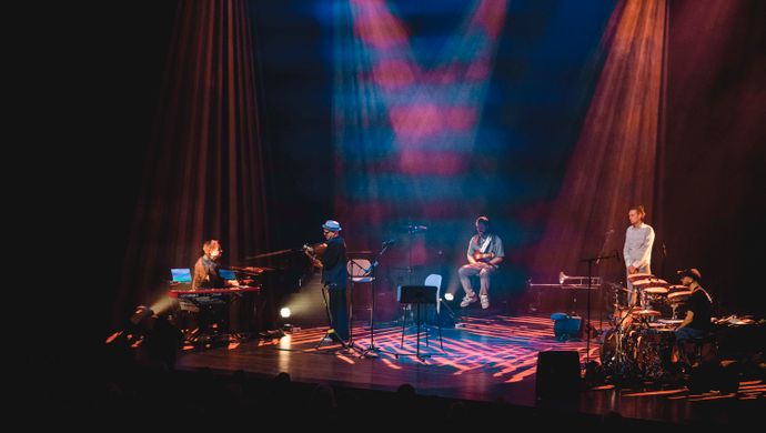 Drummer, pianist, guitarist, trumpeter and Dhafer Youssef on the stage. 